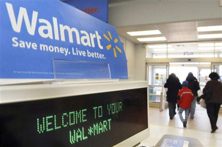 FILE - In this Feb. 17, 2009 file photo, shoppers leave a Wal-Mart in Danvers, Mass. Wal-Mart Stores Inc. is going for the jugular in the holiday retailing war, announcing Thursday, Nov. 11, 2010, that it will offer free shipping on nearly 60,000 online items _ with no minimum purchase requirement. (AP Photo/Lisa Poole, File)